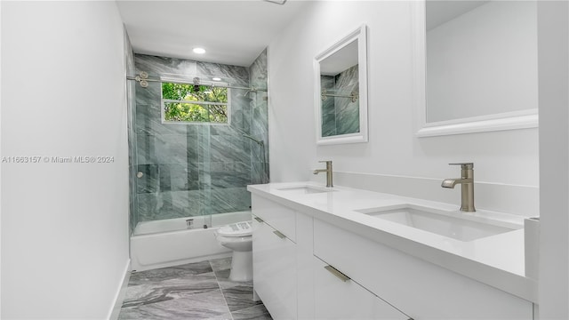 full bathroom with tiled shower / bath, vanity, and toilet