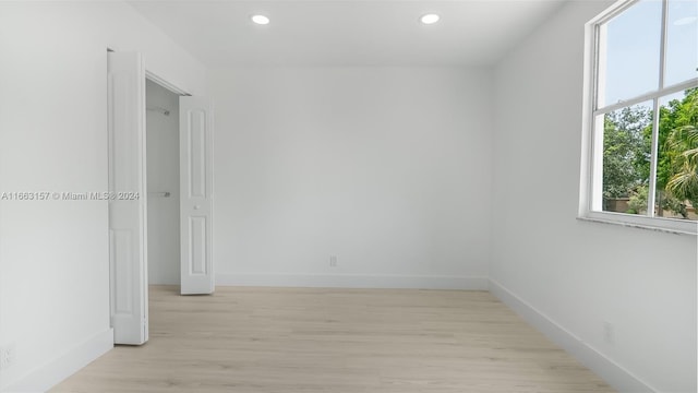 empty room with light hardwood / wood-style flooring