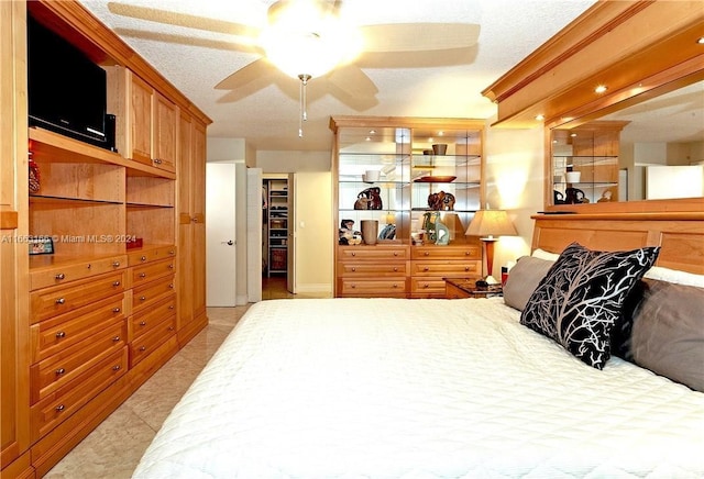 bedroom with a closet, a textured ceiling, and ceiling fan