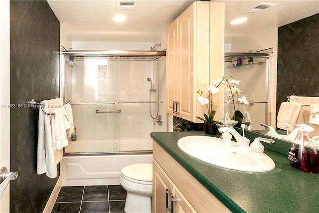 full bathroom with tile patterned flooring, enclosed tub / shower combo, vanity, and toilet