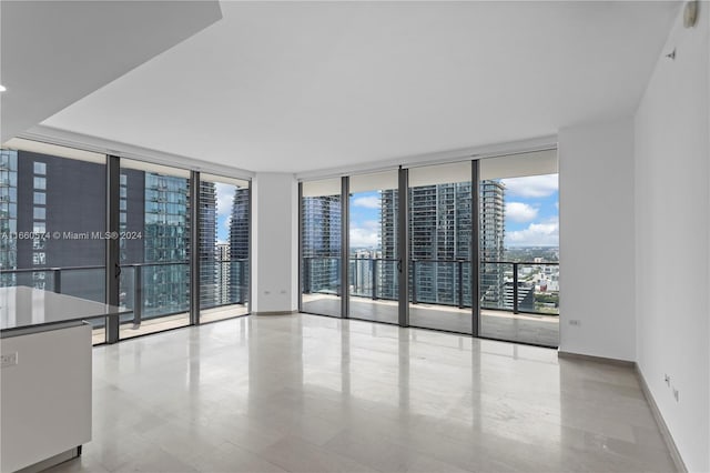 68 SE 6th St Unit 3102, Miami, FL 33131 - empty room with a wall of windows, a city view, and baseboards