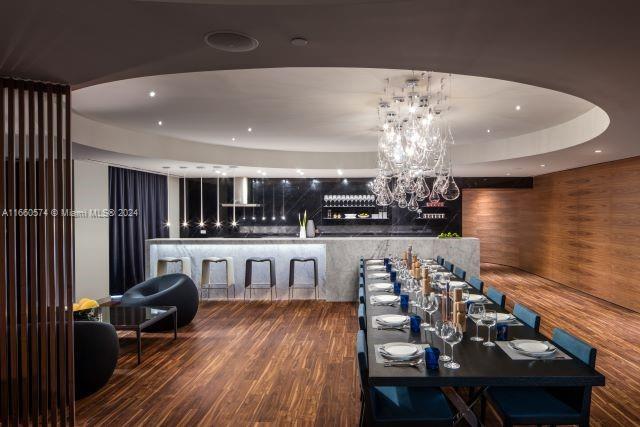 68 SE 6th St Unit 3102, Miami, FL 33131 - dining area featuring a raised ceiling, wood finished floors, and a chandelier