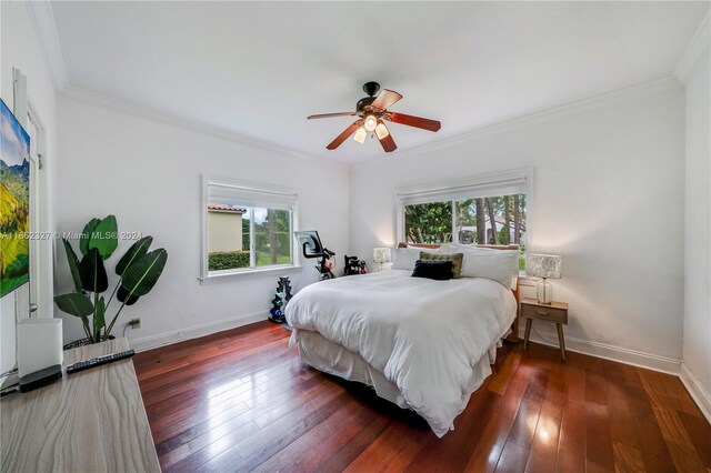 bedroom featuring ceiling fan, dark wood-type flooring, and crown molding