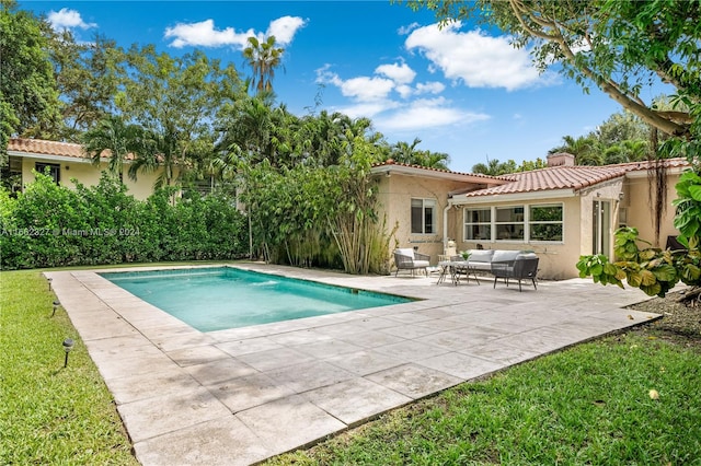 view of pool with an outdoor hangout area, a yard, and a patio area