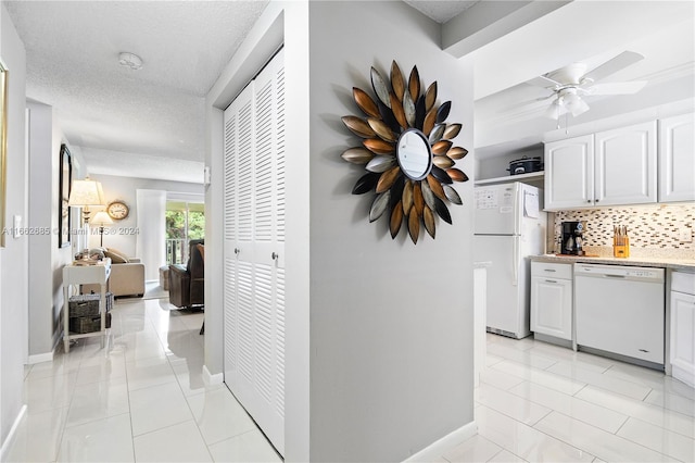 hallway featuring a textured ceiling and light tile patterned floors