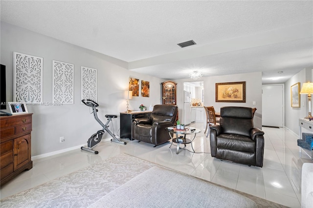 tiled living room with a textured ceiling