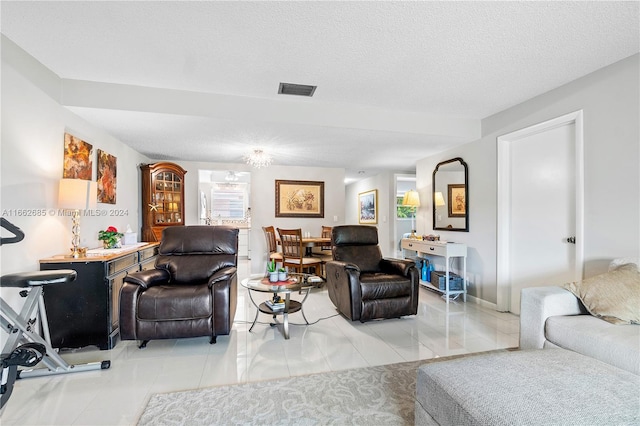 tiled living room with a textured ceiling