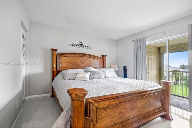 tiled bedroom featuring a textured ceiling and access to exterior