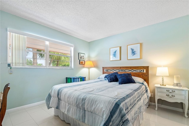 tiled bedroom featuring a textured ceiling