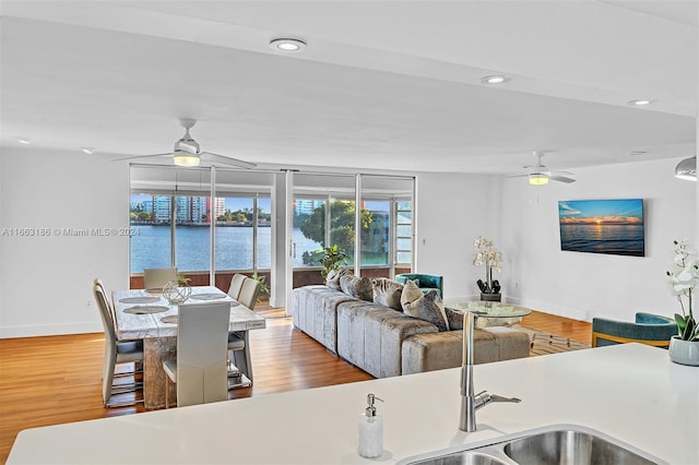 kitchen featuring a water view, ceiling fan, and hardwood / wood-style flooring