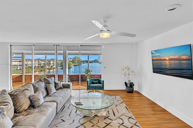 living room with ceiling fan, hardwood / wood-style flooring, and a healthy amount of sunlight