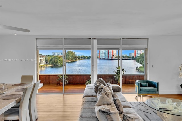 living room featuring a water view and hardwood / wood-style floors