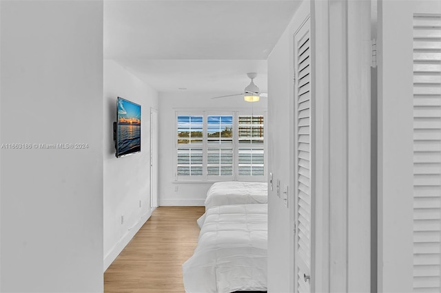 bedroom with light hardwood / wood-style flooring and ceiling fan