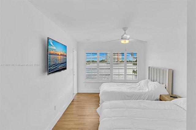 bedroom with hardwood / wood-style floors and ceiling fan