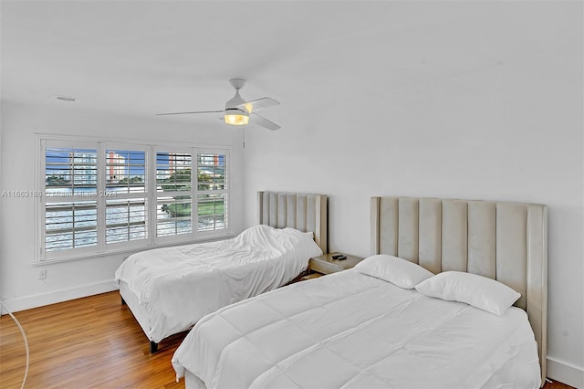 bedroom with ceiling fan and hardwood / wood-style flooring