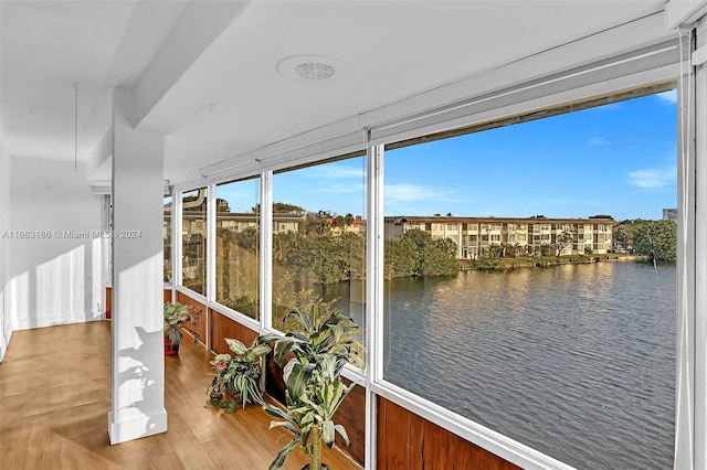 sunroom / solarium featuring a water view