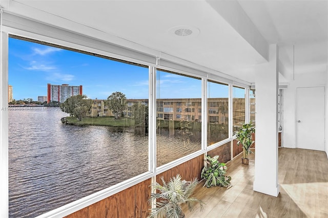 sunroom / solarium with a water view