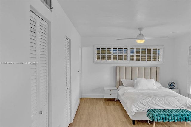 bedroom with ceiling fan and light hardwood / wood-style flooring