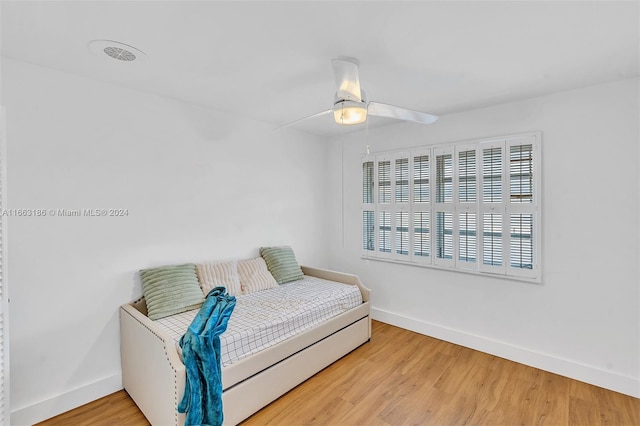 bedroom with ceiling fan and hardwood / wood-style flooring