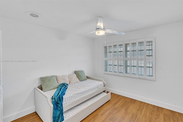 bedroom featuring hardwood / wood-style floors and ceiling fan