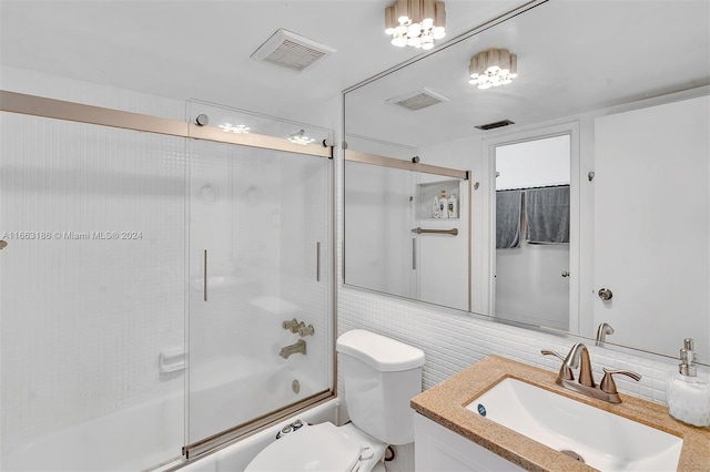 full bathroom featuring vanity, toilet, and combined bath / shower with glass door