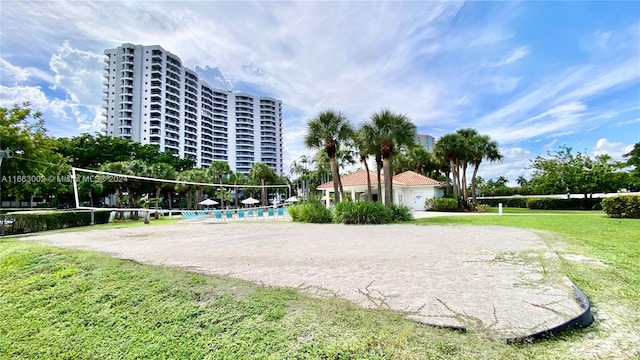 surrounding community featuring a yard and volleyball court