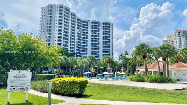 surrounding community featuring a yard and volleyball court