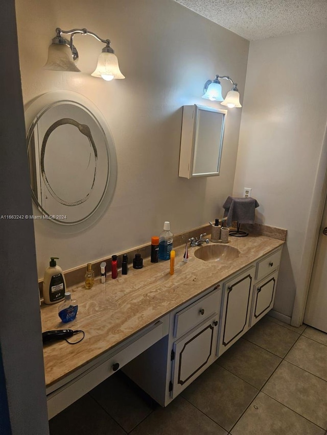 bathroom featuring vanity, tile patterned flooring, and a textured ceiling