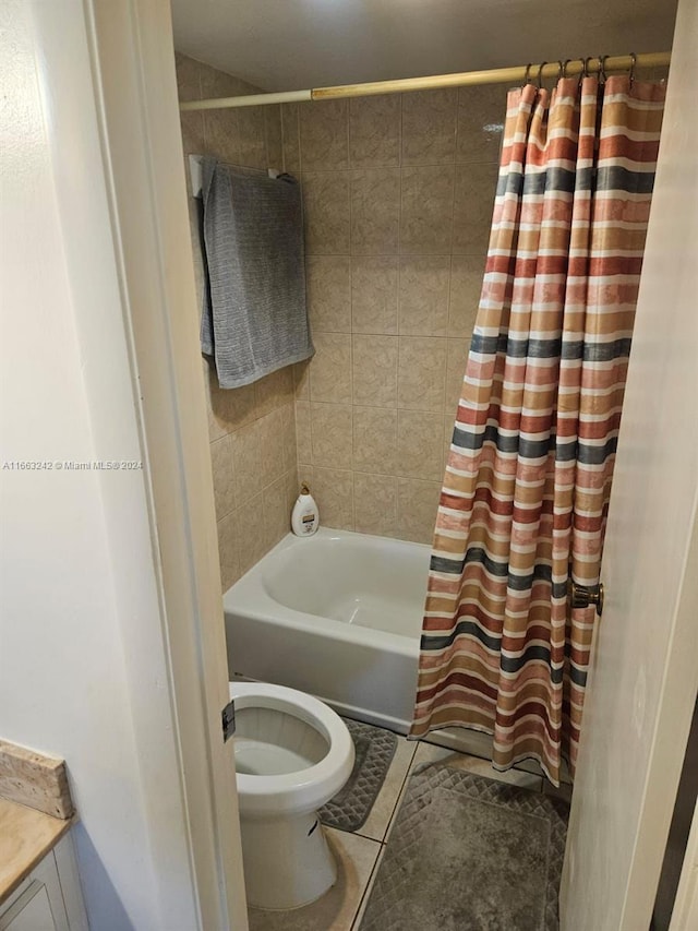 full bathroom featuring vanity, shower / bath combo, tile patterned floors, and toilet