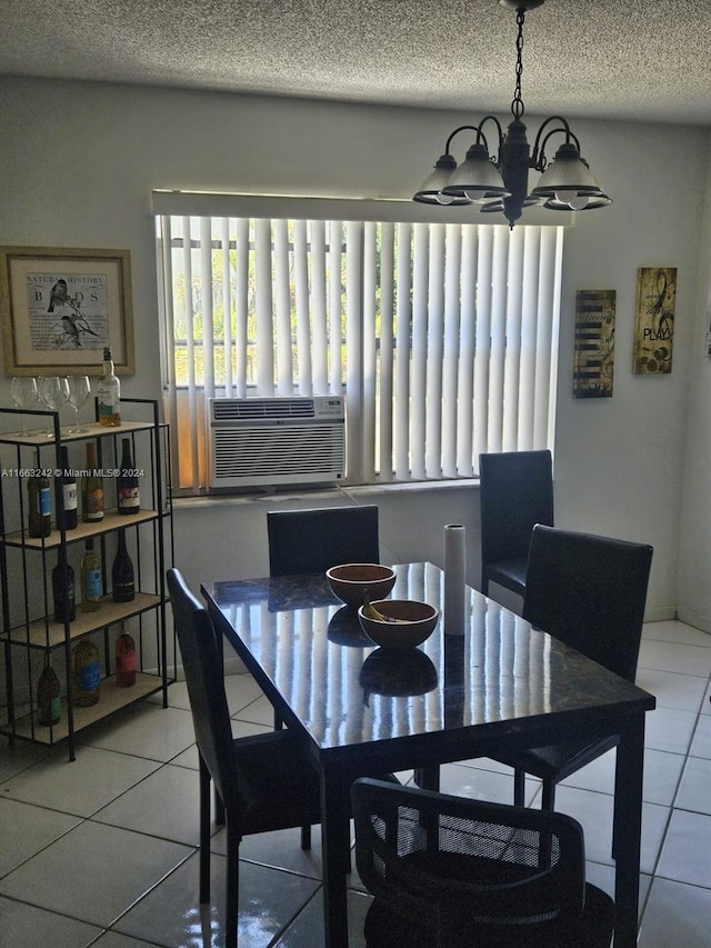 dining area featuring a textured ceiling, cooling unit, an inviting chandelier, and tile patterned floors