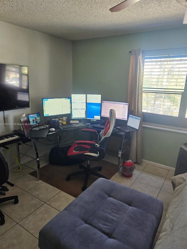 office space with ceiling fan, light tile patterned flooring, and a textured ceiling