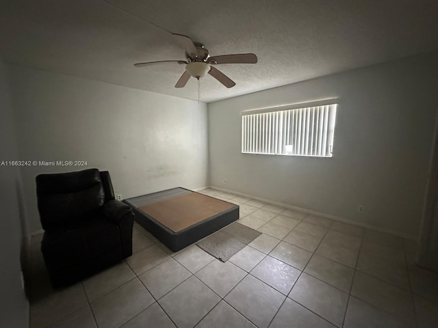 interior space featuring ceiling fan and light tile patterned floors