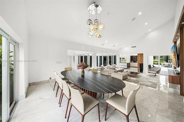 dining area featuring a chandelier, high vaulted ceiling, and a wealth of natural light