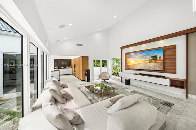 living room featuring high vaulted ceiling