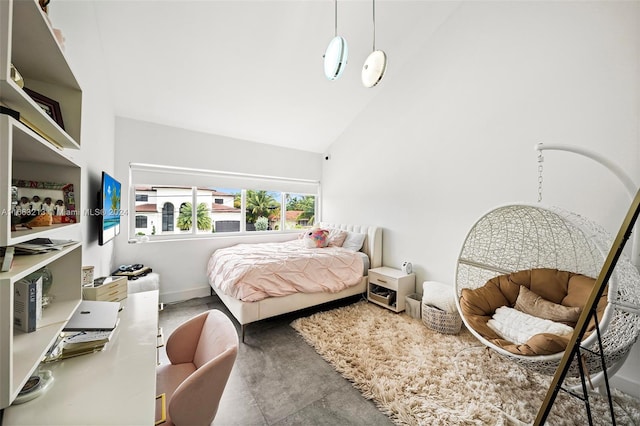 bedroom featuring concrete flooring and high vaulted ceiling