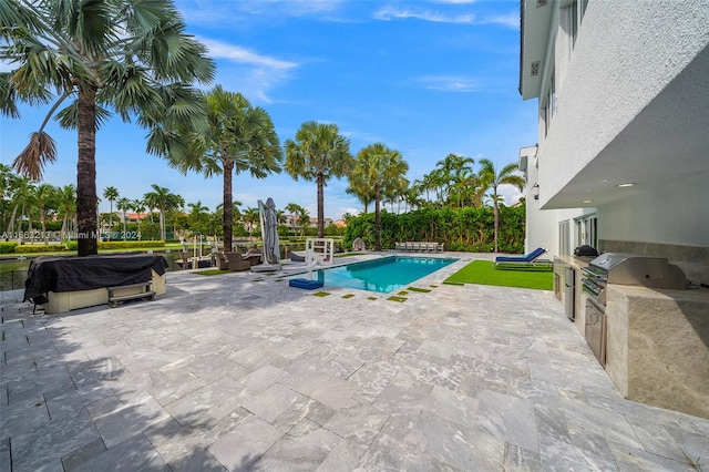 view of swimming pool featuring area for grilling and a patio