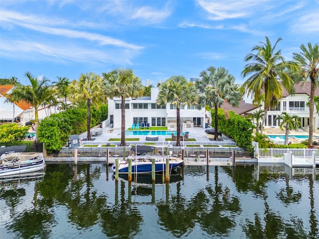 dock area with a pool, a water view, and a patio area