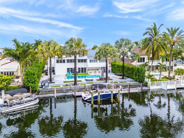 dock area featuring a water view, a pool, and a patio area