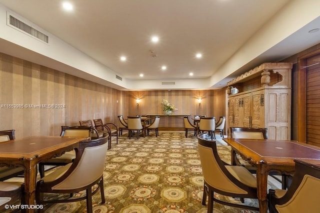 dining room featuring wooden walls