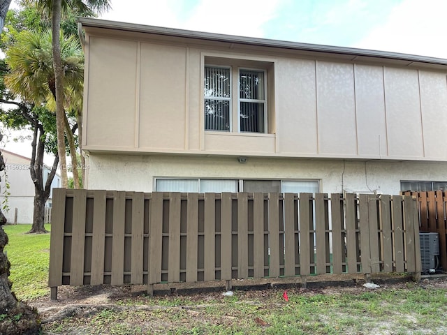 view of side of property featuring central air condition unit