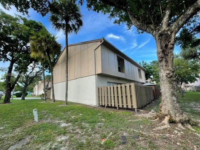 view of side of home with a yard