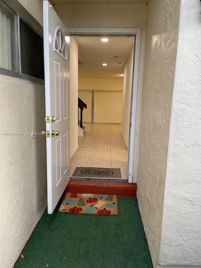 hallway with tile patterned flooring