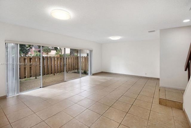 spare room featuring light tile patterned floors