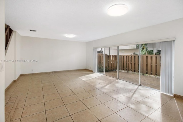 empty room with light tile patterned flooring