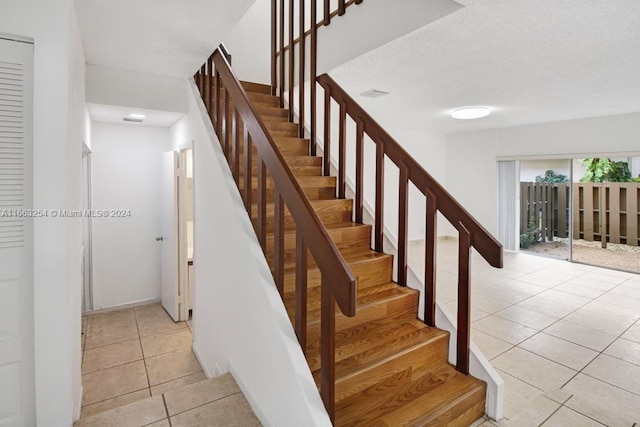 stairs featuring tile patterned flooring