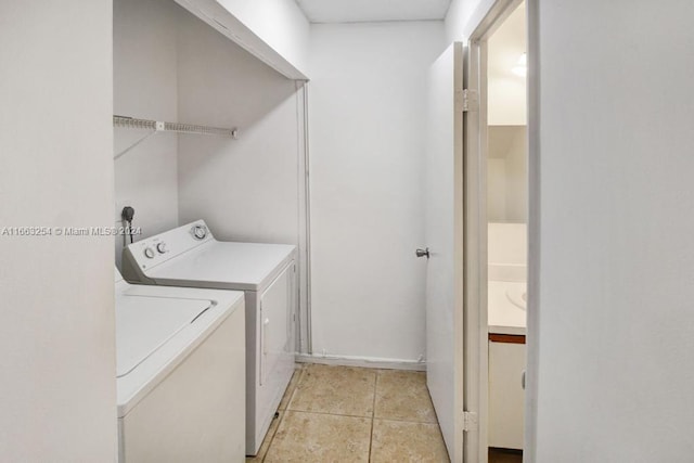 laundry room with light tile patterned floors and washer and dryer