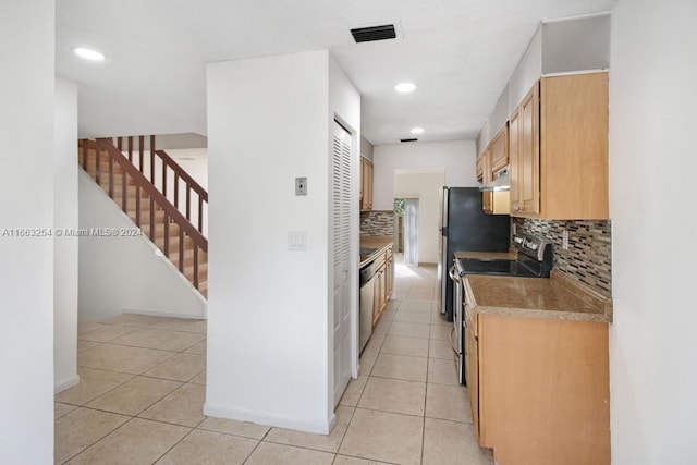 kitchen featuring light brown cabinets, appliances with stainless steel finishes, backsplash, and light tile patterned floors