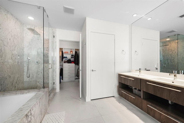 bathroom with vanity, shower with separate bathtub, and tile patterned floors