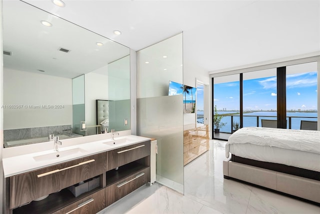 interior space featuring vanity, expansive windows, and a water view