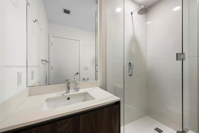 bathroom with vanity and a shower with shower door